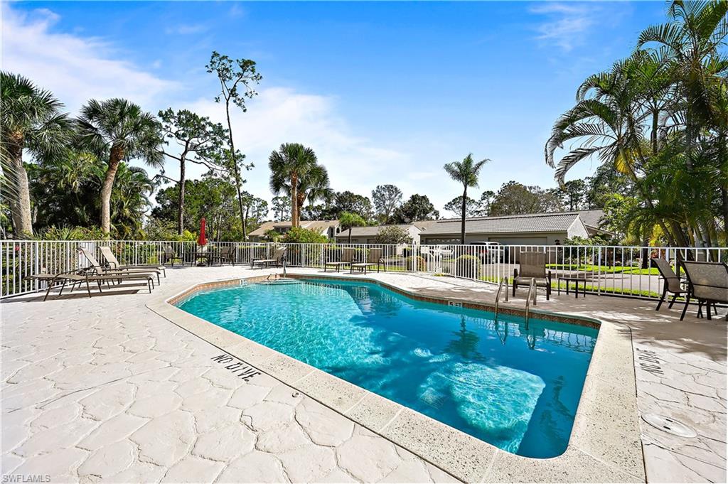 938 Augusta Boulevard, Unit D937 Naples, FL 34113 - Photo 27 of 27 a view of swimming pool with outdoor seating and plants