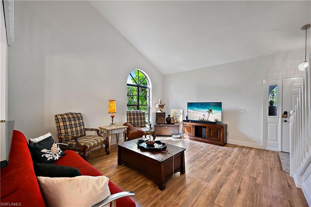 938 Augusta Boulevard, Unit D937 Naples, FL 34113 - Photo 7 of 27 a living room with furniture and a flat screen tv