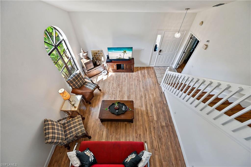 938 Augusta Boulevard, Unit D937 Naples, FL 34113 - Photo 8 of 27 a living room with furniture and wooden floor