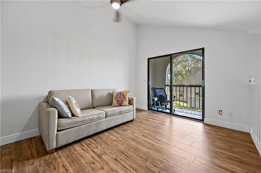 938 Augusta Boulevard, Unit D937 Naples, FL 34113 - Photo 10 of 27 a living room with furniture and a large window