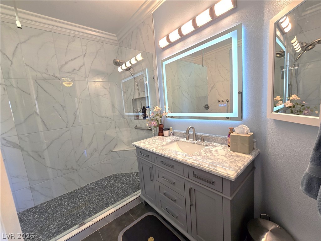 2050 West Warm Springs Road, Unit 2422 Henderson, NV 89014 - Photo 24 of 44 This sleek bathroom features a modern vanity and a spacious, glass-enclosed shower.