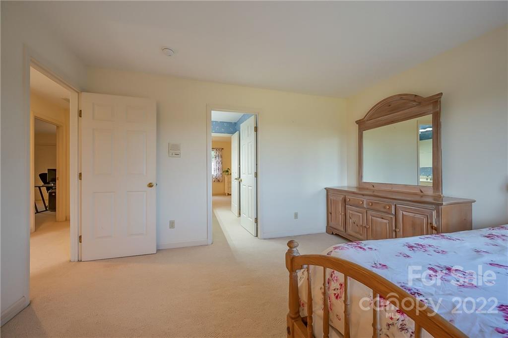 161 Walker Road Mill Spring, NC 28756 - Photo 23 of 47 a bedroom with a bed and a dresser in it