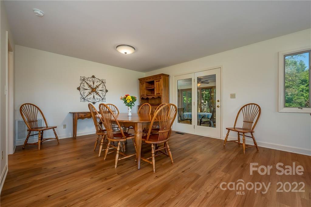161 Walker Road Mill Spring, NC 28756 - Photo 8 of 47 a view of a dining room with furniture window and wooden floor