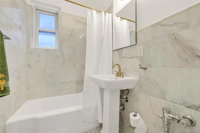 a bathroom with a sink a mirror and a bathtub