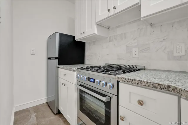 a stove top oven sitting inside of a kitchen
