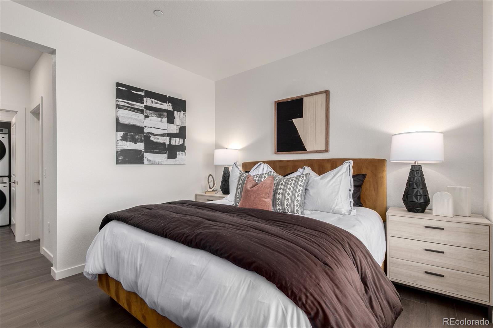 6153 North Ceylon Street, Unit 204 Denver, CO 80249 - Photo 12 of 22 a bedroom with a bed and a night stand