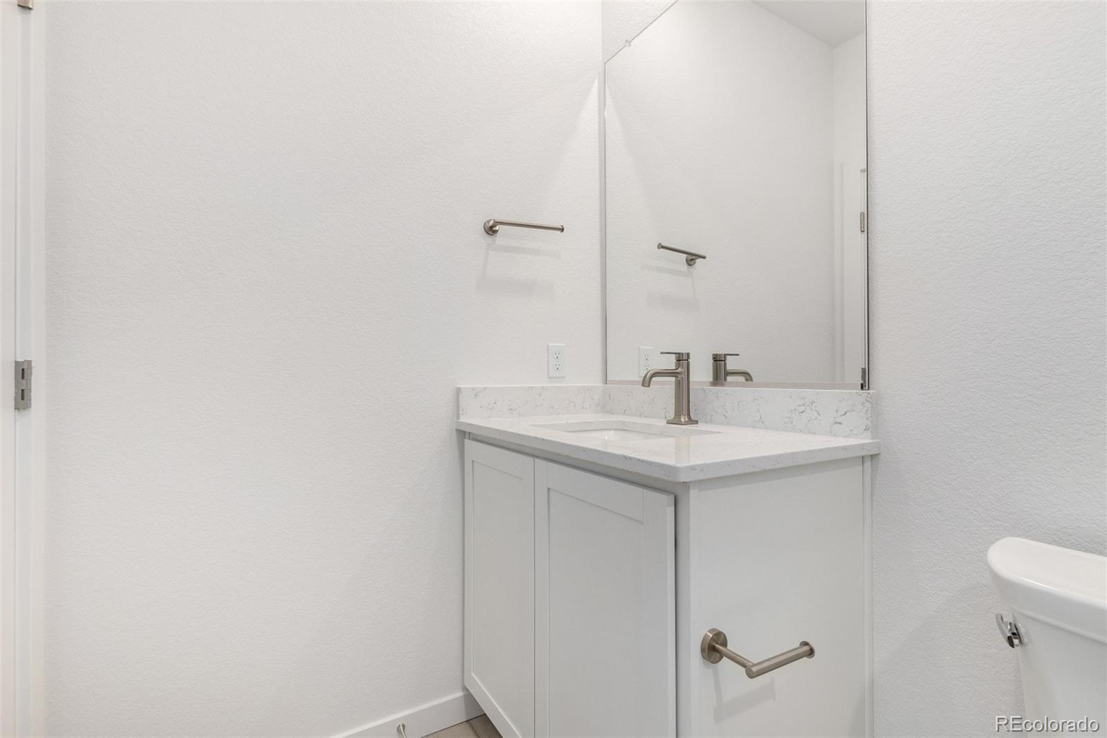 6153 North Ceylon Street, Unit 204 Denver, CO 80249 - Photo 15 of 22 a bathroom with a sink and a mirror