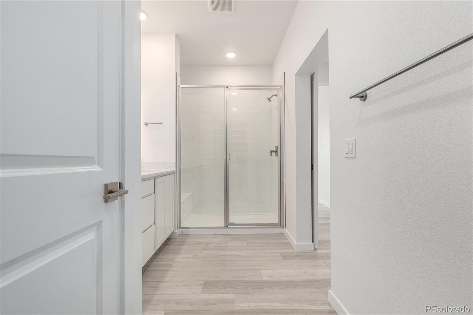 6153 North Ceylon Street, Unit 204 Denver, CO 80249 - Photo 17 of 22 a view of a hallway with white walls and wooden door