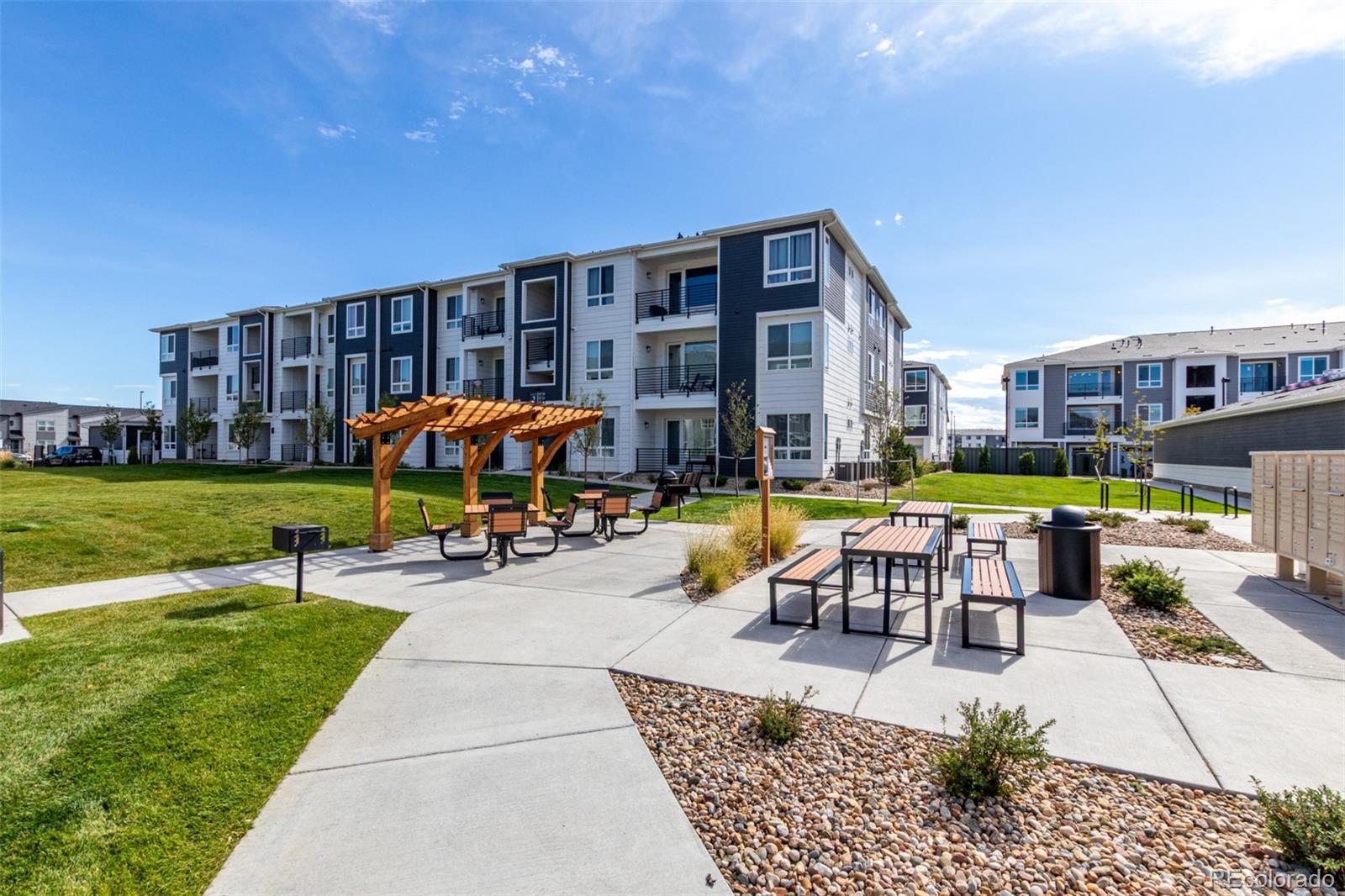 6153 North Ceylon Street, Unit 204 Denver, CO 80249 - Photo 22 of 22 a view of swimming pool with outdoor seating and a garden
