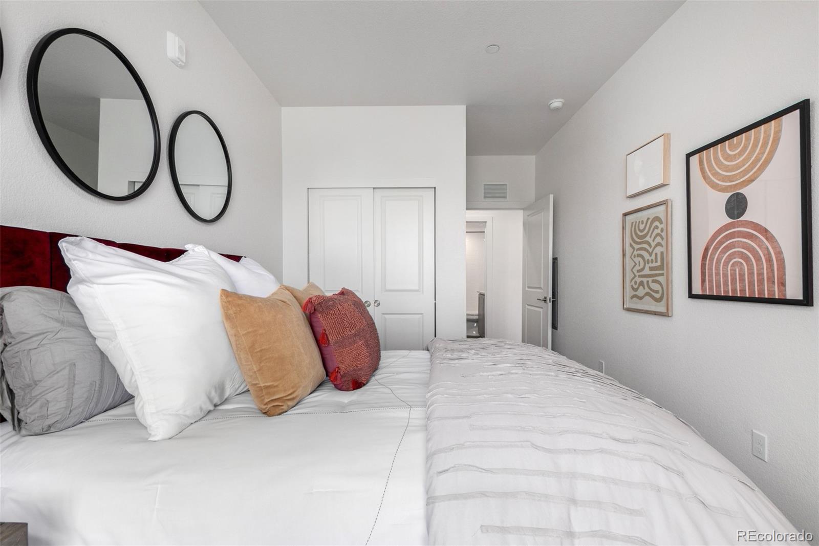 6153 North Ceylon Street, Unit 204 Denver, CO 80249 - Photo 7 of 22 a bedroom with a bed and a painting on the wall