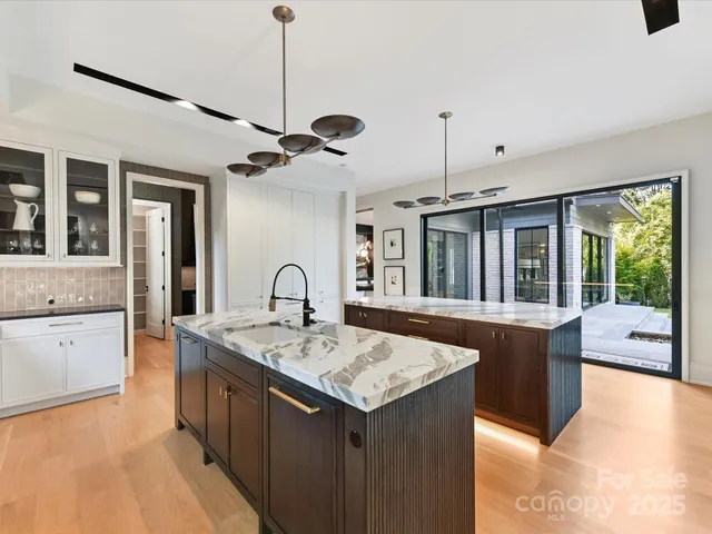a open kitchen with stainless steel appliances granite countertop a sink and dishwasher with a dining table