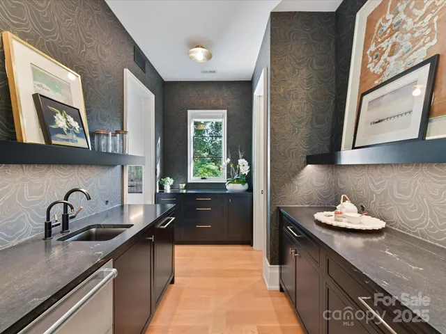 a kitchen with stainless steel appliances granite countertop a sink stove and cabinets