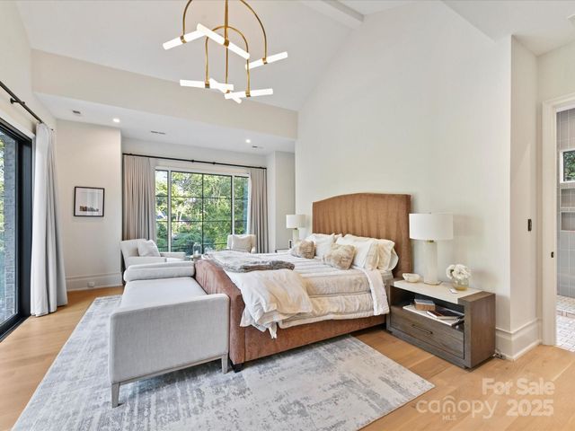 a bedroom with a large bed couch and a window