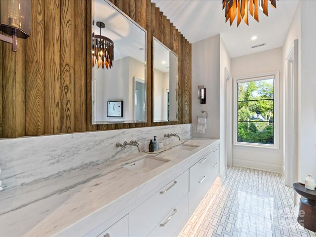 a spacious bathroom with a double vanity sink and a mirror