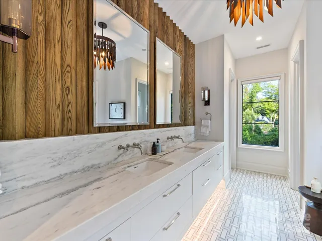 a spacious bathroom with a double vanity sink and a mirror