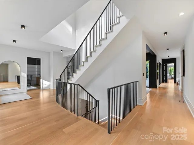 a view of staircase with lots of frames and a rug