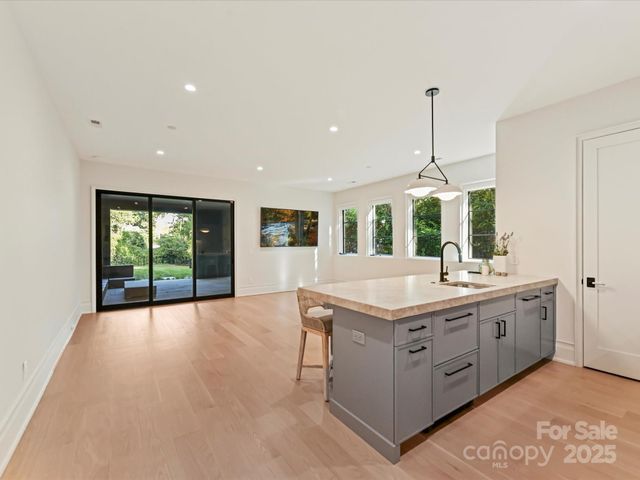 a view of kitchen and kitchen with a chandelier
