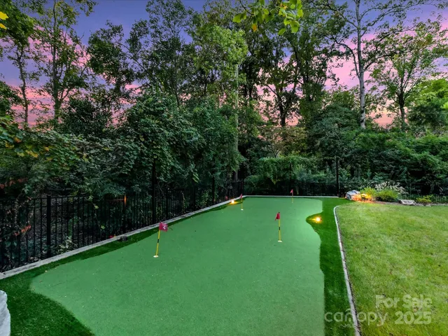 a green field with lots of trees