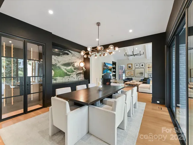 a large kitchen with kitchen island a large window in it