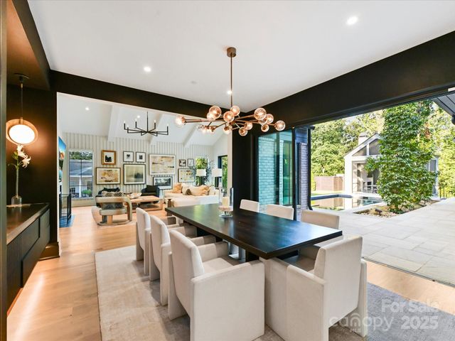 a kitchen with stainless steel appliances granite countertop a sink a stove and a wooden floors