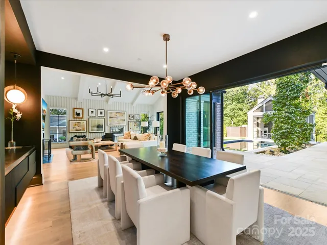 a kitchen with stainless steel appliances granite countertop a sink a stove and a wooden floors