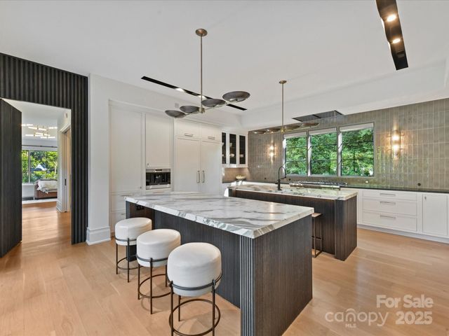 a kitchen with stainless steel appliances granite countertop counter space a sink refrigerator and window