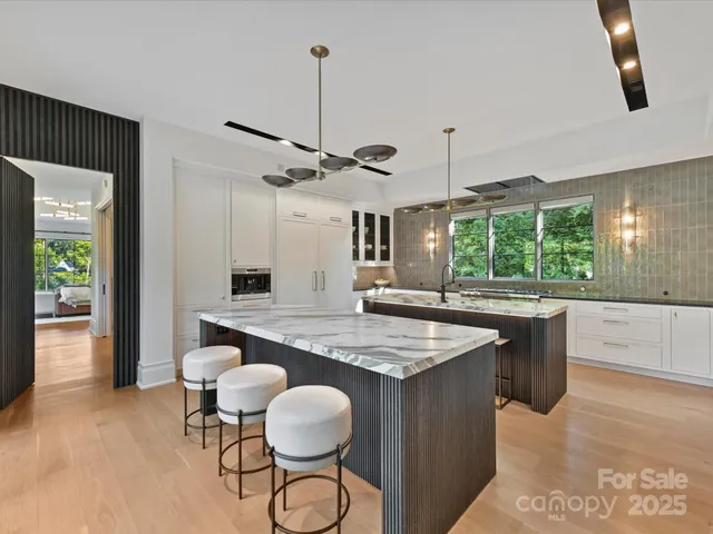 a kitchen with stainless steel appliances granite countertop counter space a sink refrigerator and window