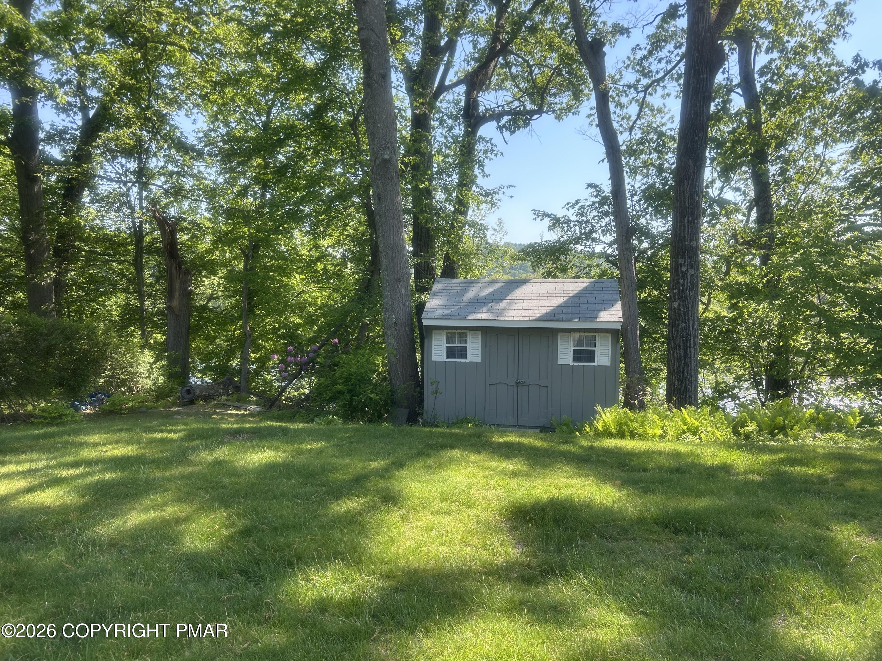4379 River Road Mount Bethel, PA 18343 - Photo 10 of 48 a backyard of a house with table and chairs