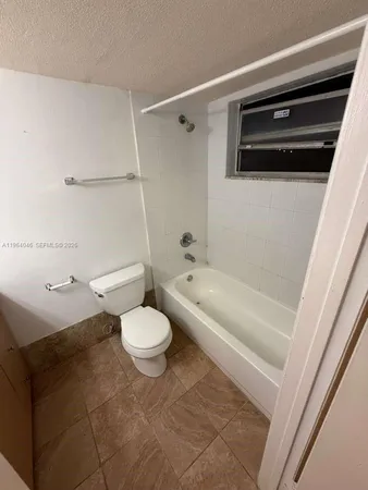 a bathroom with a toilet a sink and bathtub