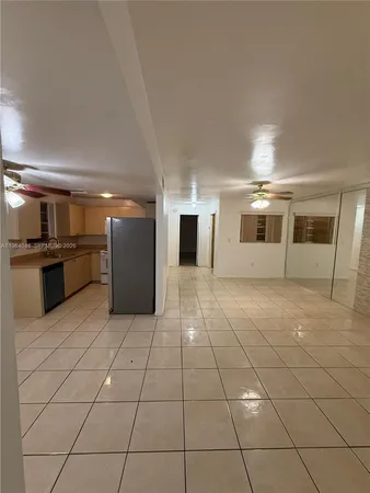 a large white kitchen with a sink and large appliances