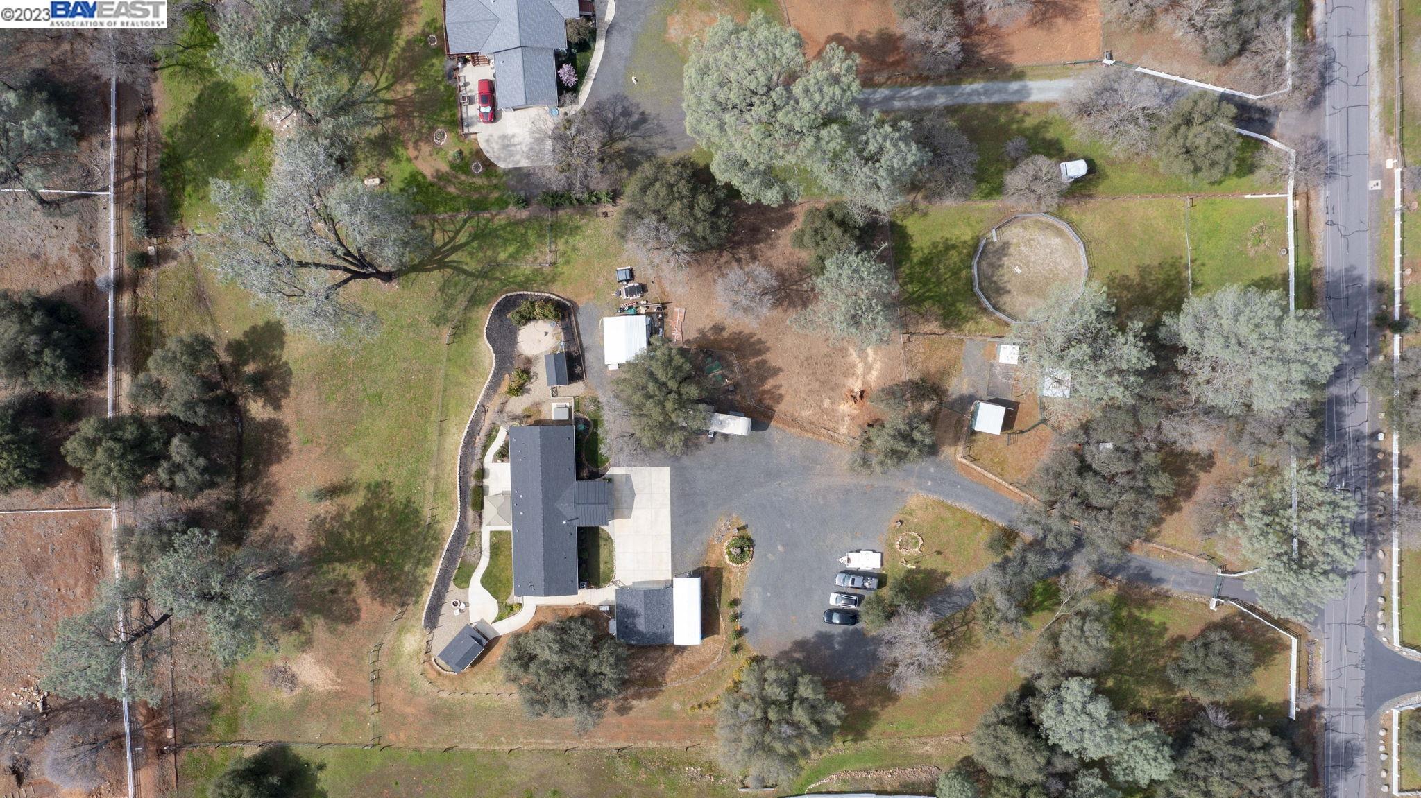 an aerial view of a house with a yard and garden