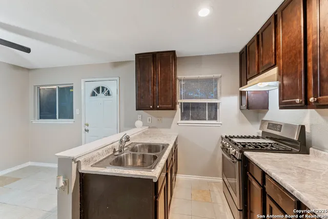a kitchen that has a sink and a stove