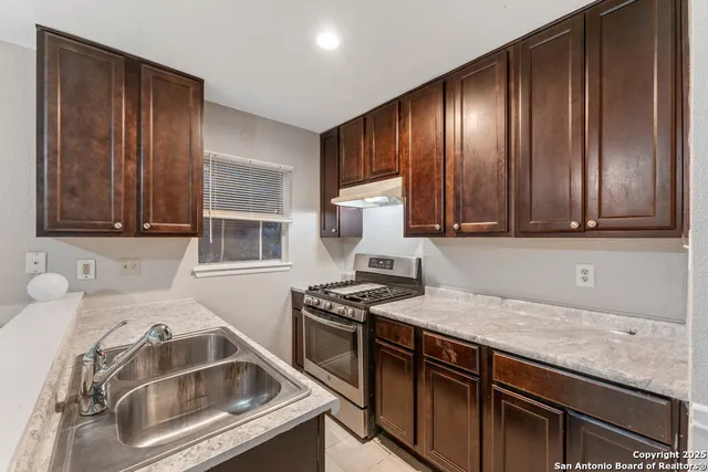 a kitchen that has a sink and a stove