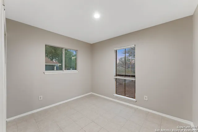 an empty room with windows and closet