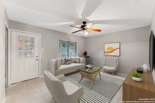 a living room with furniture a chandelier and a window