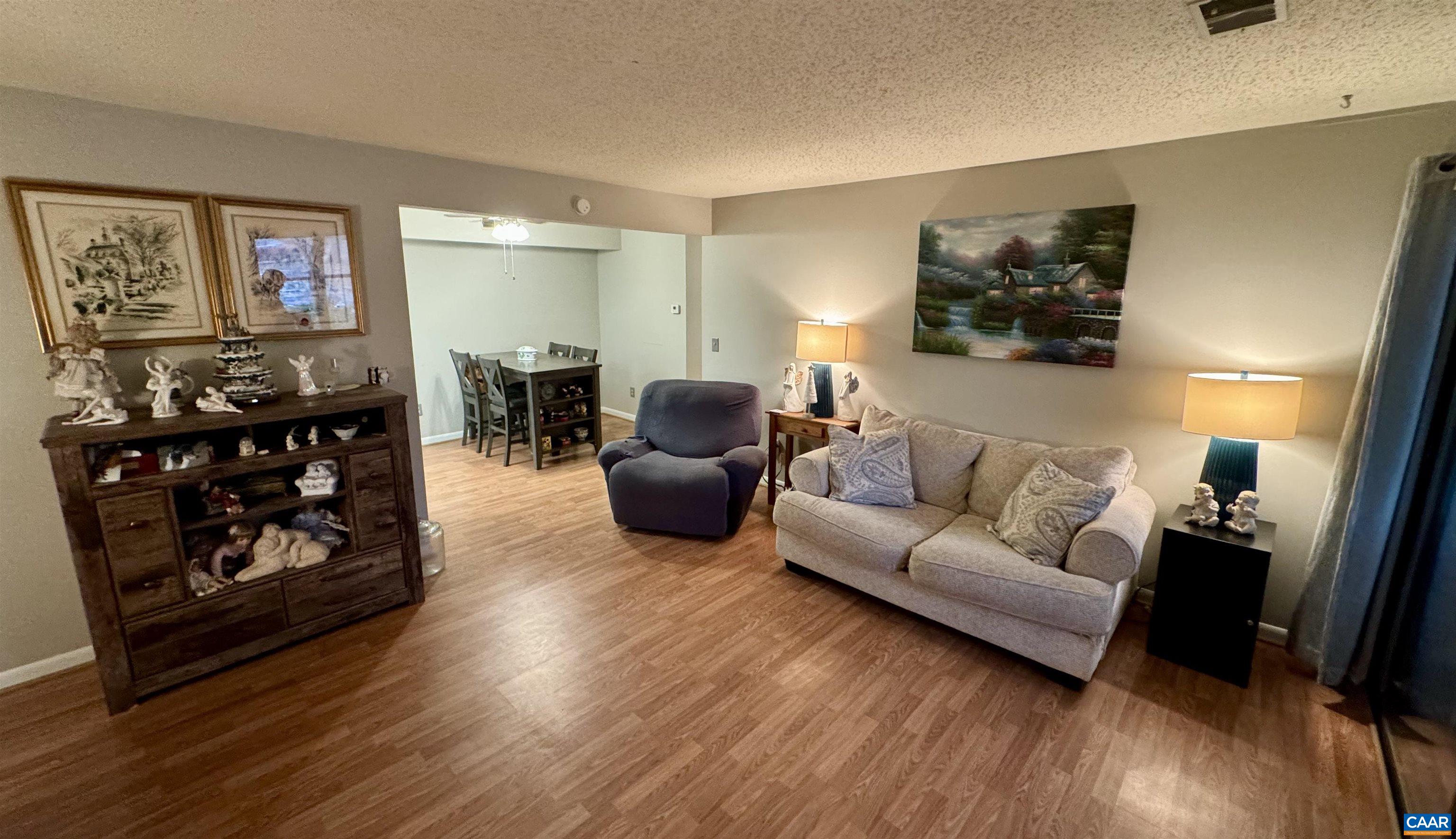 109 Turtle Creek Road, Unit 4 Charlottesville, VA 22901 - Photo 1 of 11 a living room with furniture and wooden floor