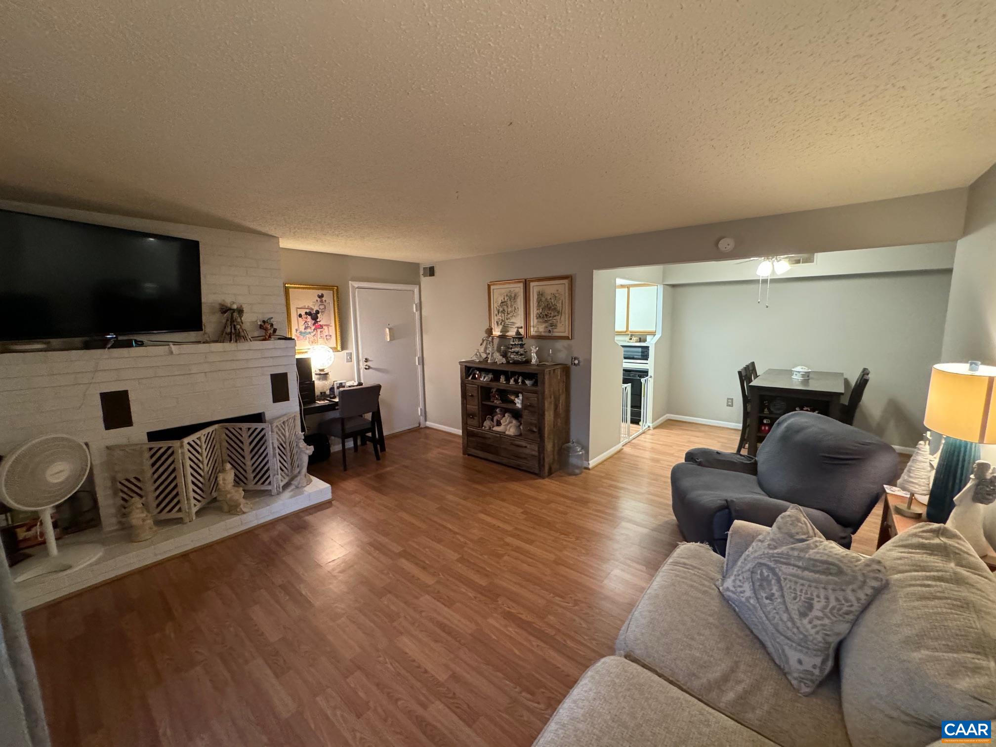109 Turtle Creek Road, Unit 4 Charlottesville, VA 22901 - Photo 3 of 11 a living room with furniture and a flat screen tv