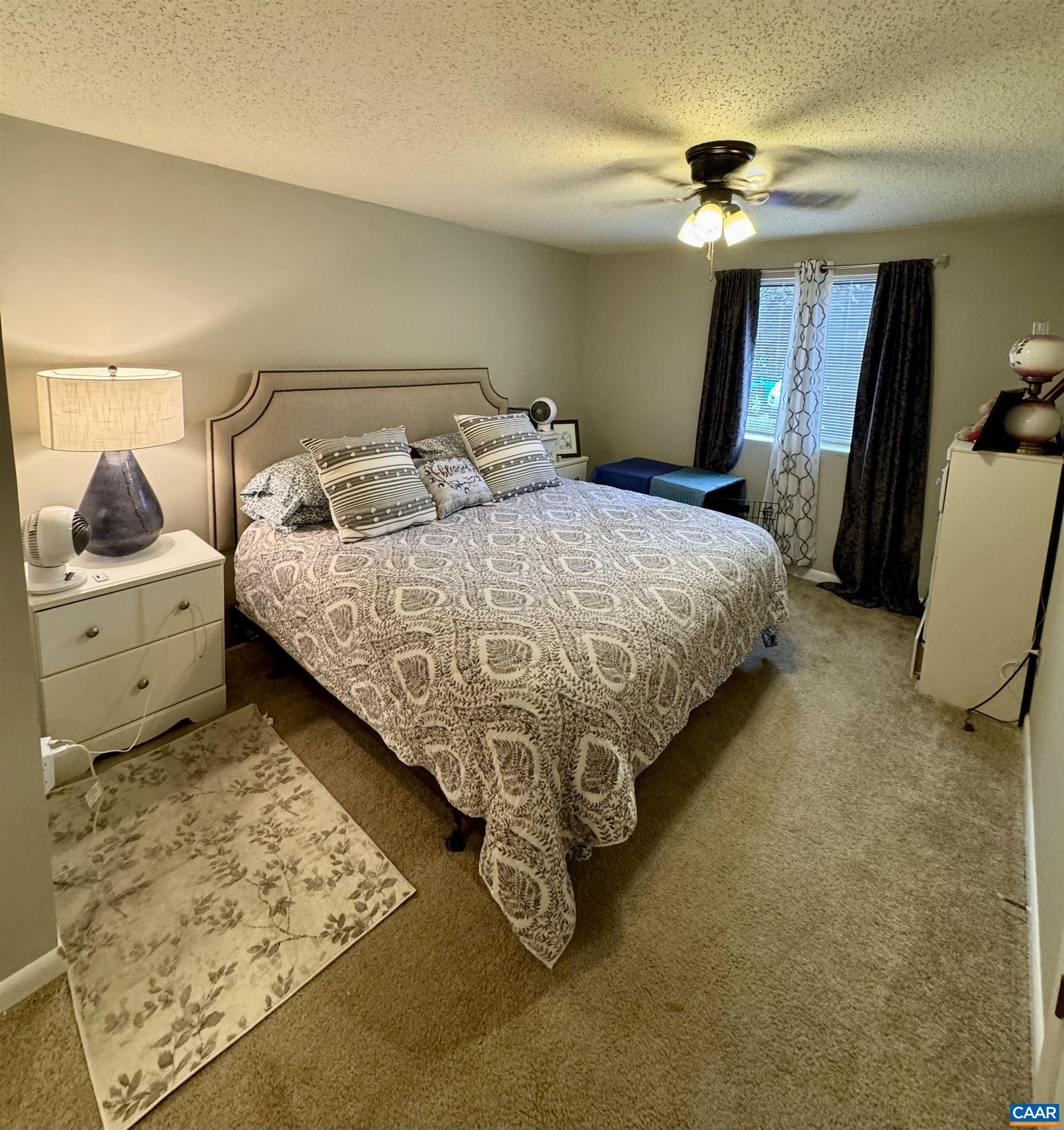 109 Turtle Creek Road, Unit 4 Charlottesville, VA 22901 - Photo 8 of 11 a bed sitting in a bedroom and with mirror