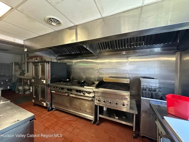a view of empty room with wooden floor and window