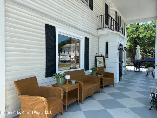 a front view of a house with yard and trees
