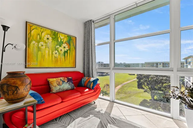 a sitting area with furniture and next to a window