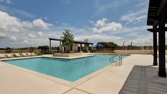a view of outdoor space with swimming pool and seating