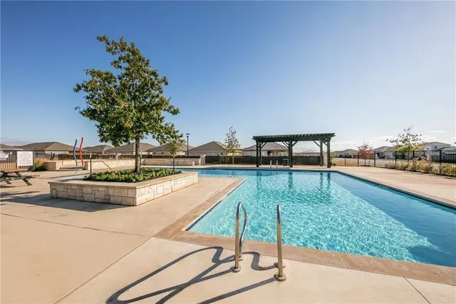 a view of swimming pool with a yard
