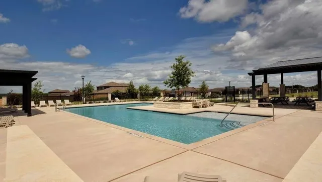 a view of swimming pool with outdoor seating and plants