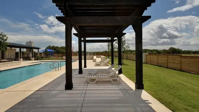 a view of swimming pool with outdoor seating