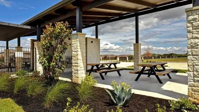 a building outdoor space with patio furniture and potted plants