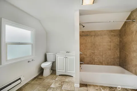 a bathroom with a toilet a sink and bathtub