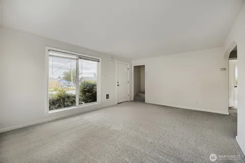 a view of an empty room with large windows