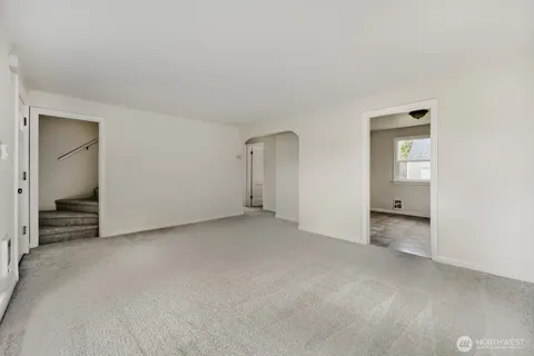 an empty room with closet and a bathroom