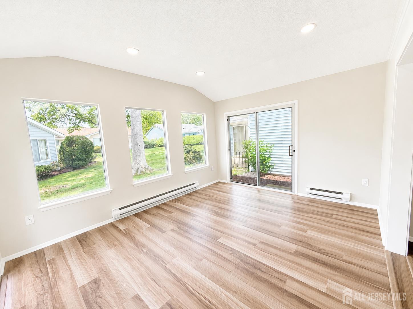 621 A Deal Road Monroe Township, NJ 08831 - Photo 12 of 27 a view of an empty room with wooden floor and a window